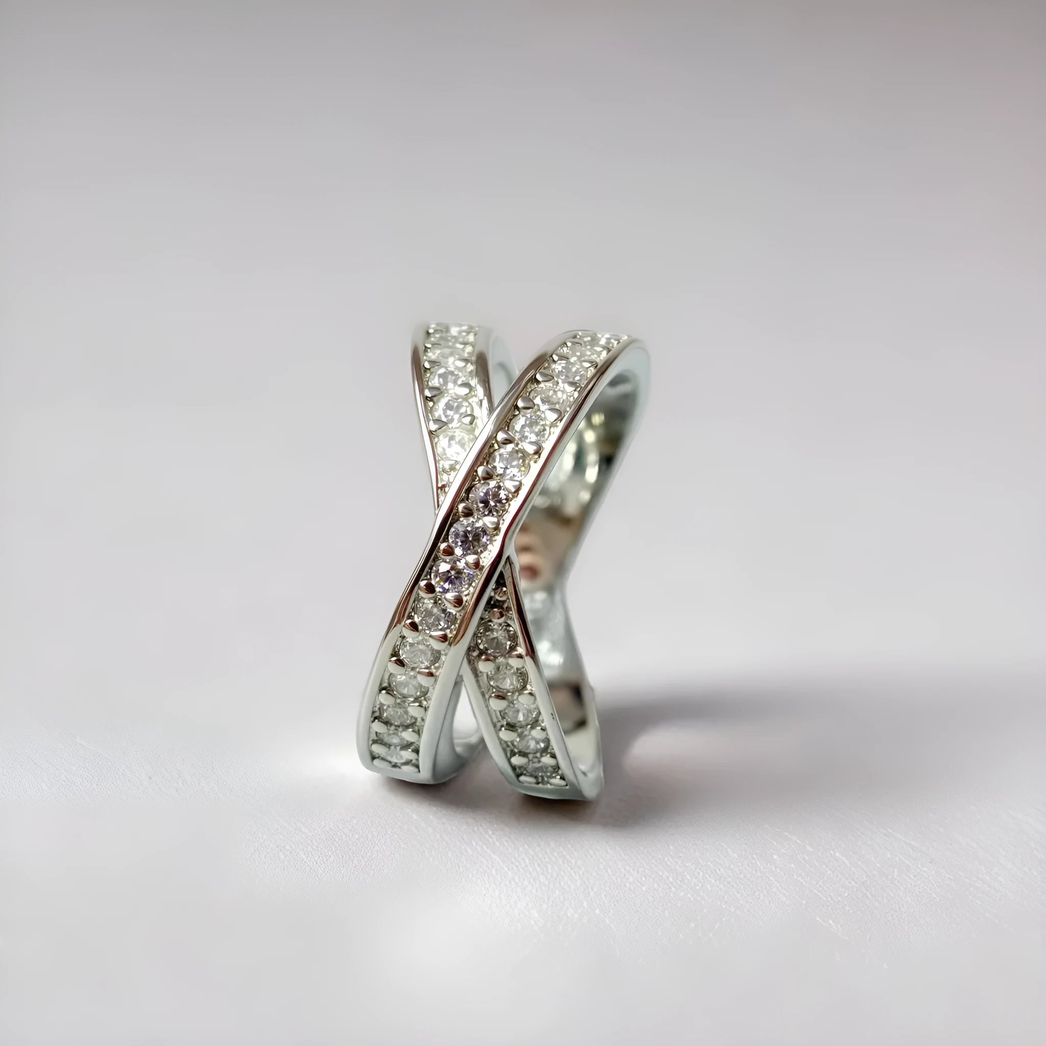 Silver or rose gold metal ring featuring a cross design with micro-inlaid zircon stones.