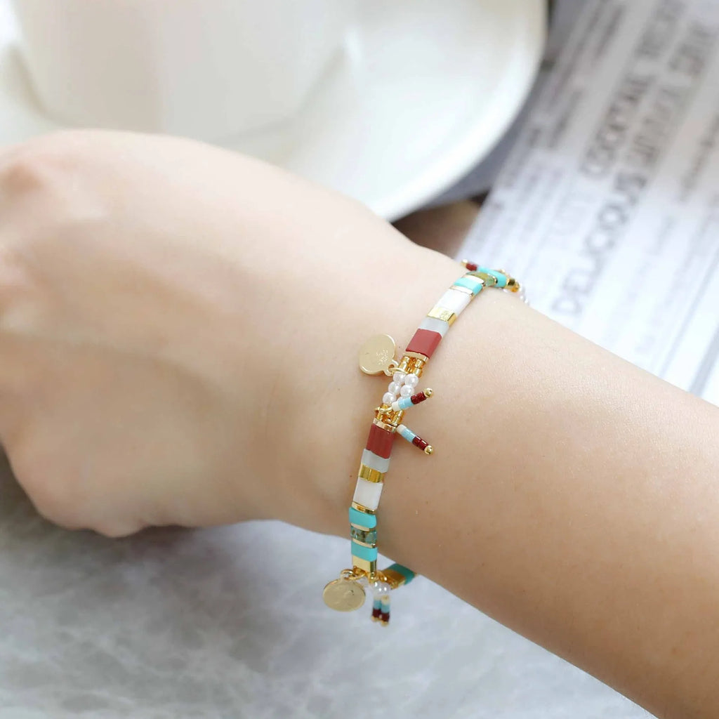 Women's imitation pearl and glass beaded bracelet showing six different colour variations with adjustable closure