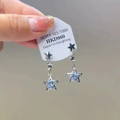 Alloy geometric heart ear clip with rhinestones and a star tassel, shown in a light luxury fresh style.