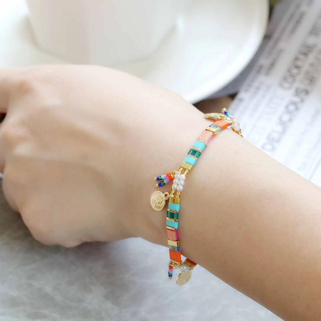 Women's imitation pearl and glass beaded bracelet showing six different colour variations with adjustable closure