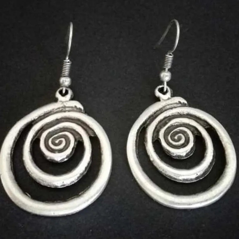 Retro geometric spiral distressed silver alloy earrings showing textured finish and spiral shape