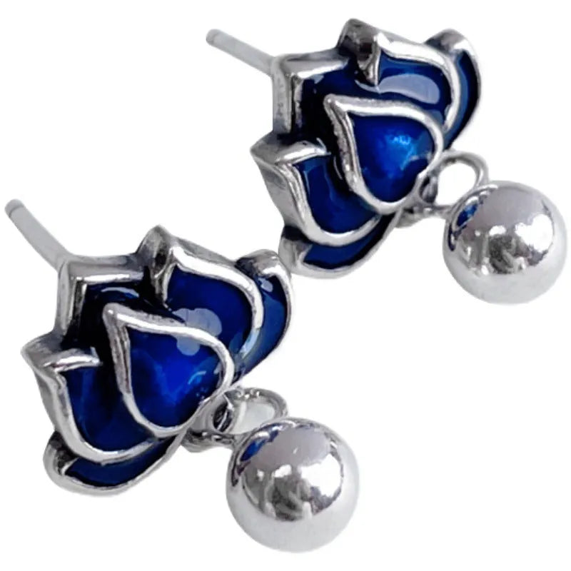 A pair of blue alloy lotus ear studs with a retro artistic seedpod and tassel design.