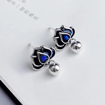 A pair of blue alloy lotus ear studs with a retro artistic seedpod and tassel design.