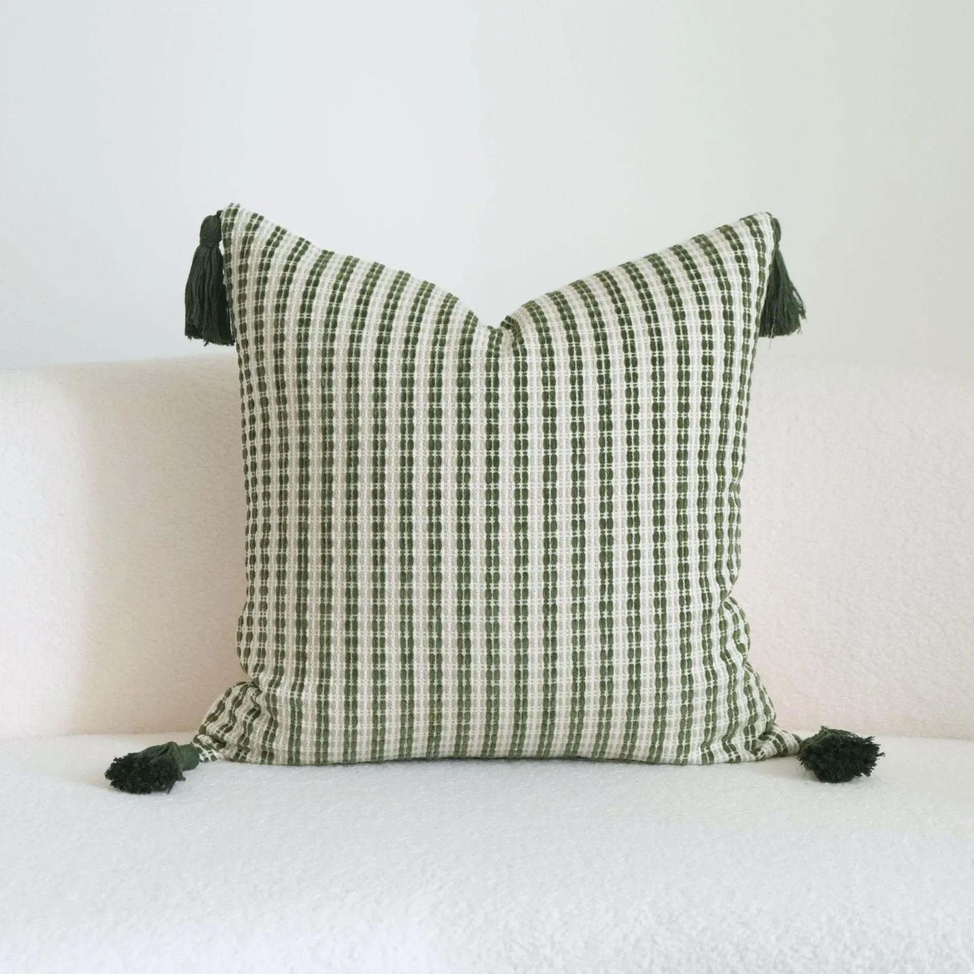 Green cotton linen hotel sample pillow with tassel detail in striped or leaf patterns