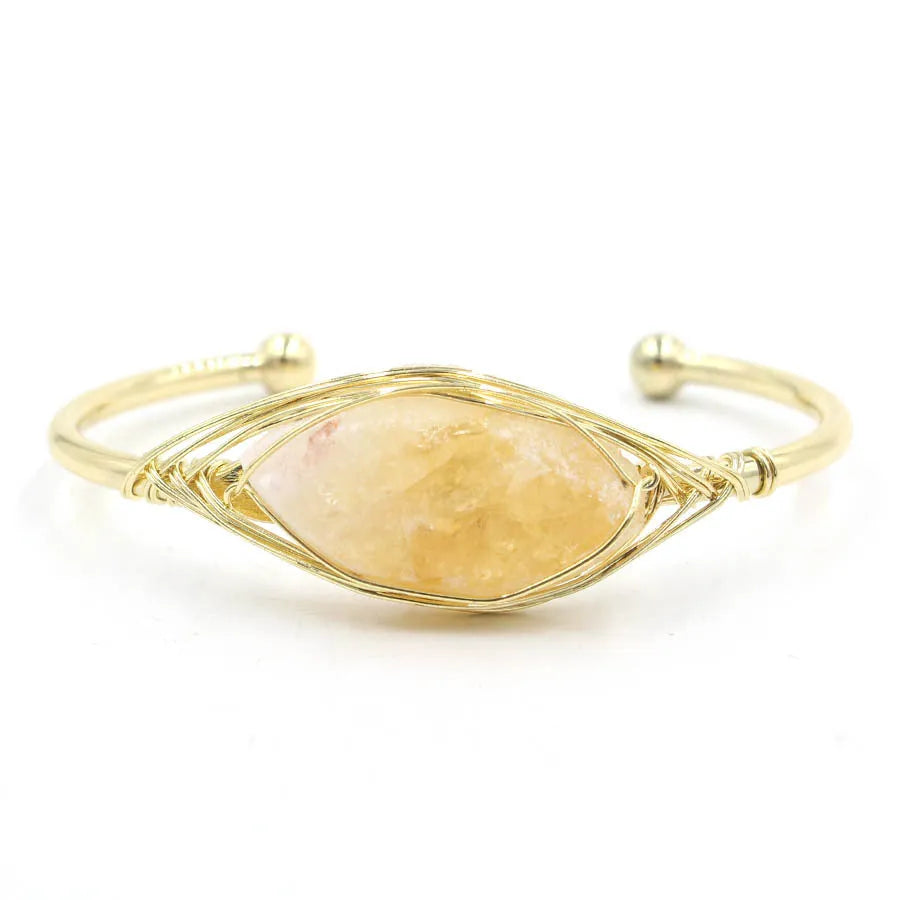 Raw gemstone winding bracelet with 8mm amorphous crystal beads in various colours on a white background.