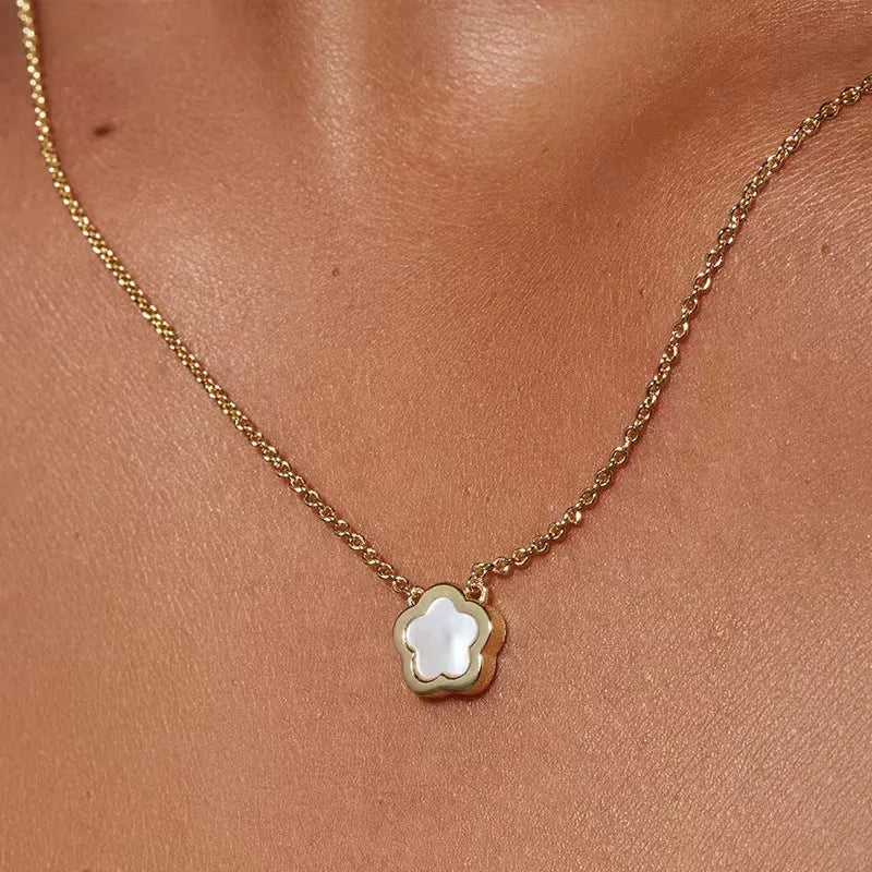 White mother of pearl shell flower necklace on a chain, shown in silver and gold tone finishes.