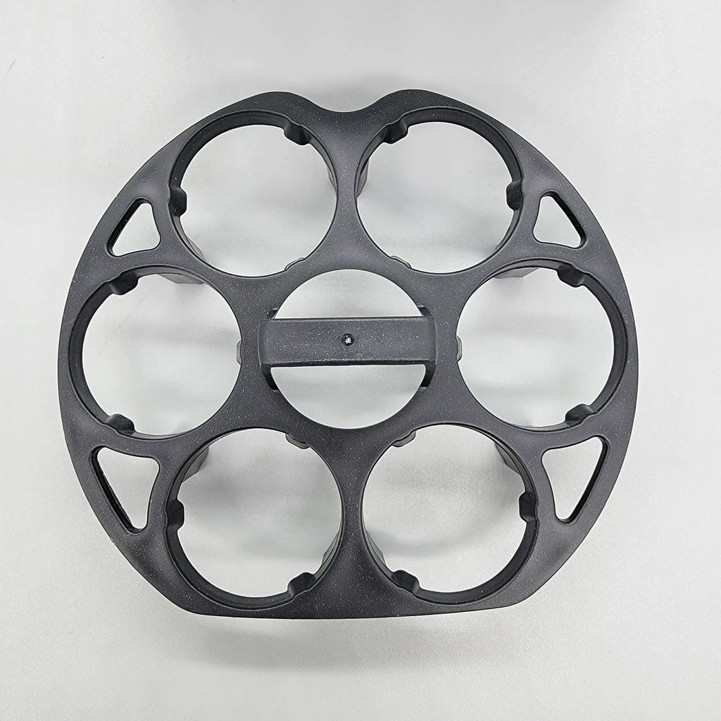 Black plastic egg holder basket on a kitchen countertop, showing its 13.8 cm length and retainer design.