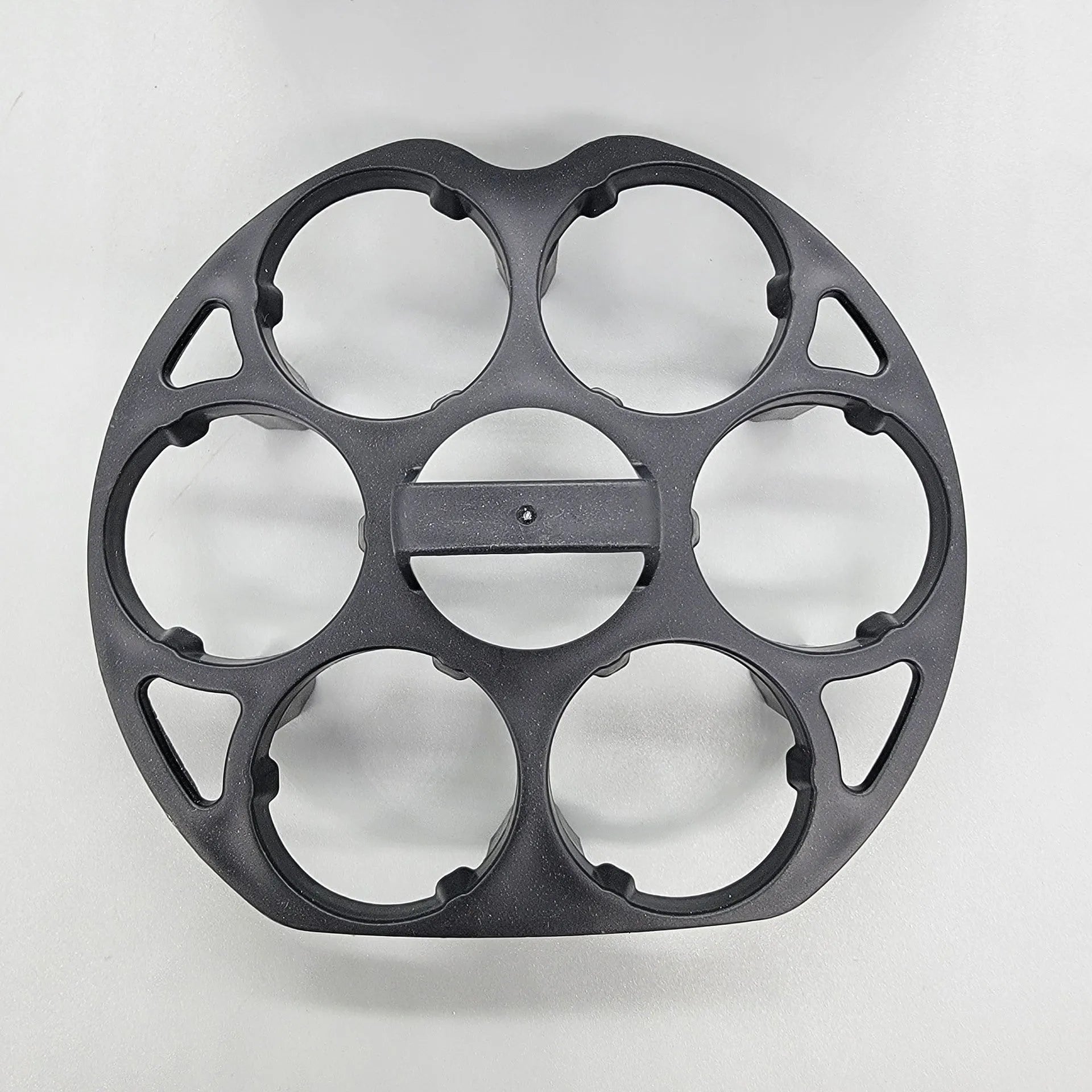 Black plastic egg holder basket on a kitchen countertop, showing its 13.8 cm length and retainer design.