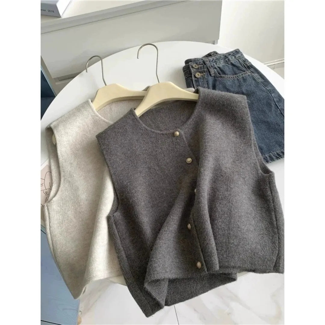 Women's grey V-neck polyester pullover vest with half-length sleeves laid flat