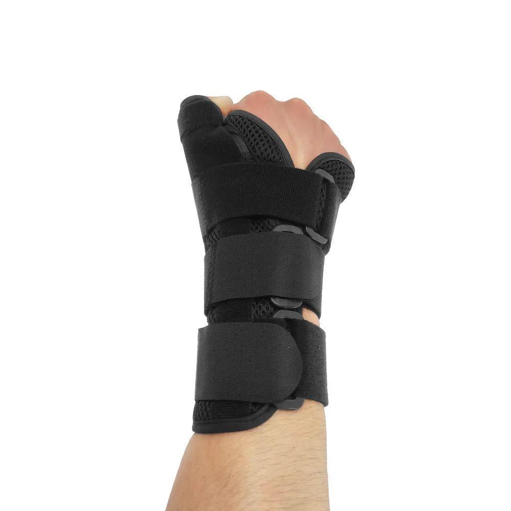 Black sports wrist guard with grey edging and a thumb strap, showing carbon fibre reinforcement panel.