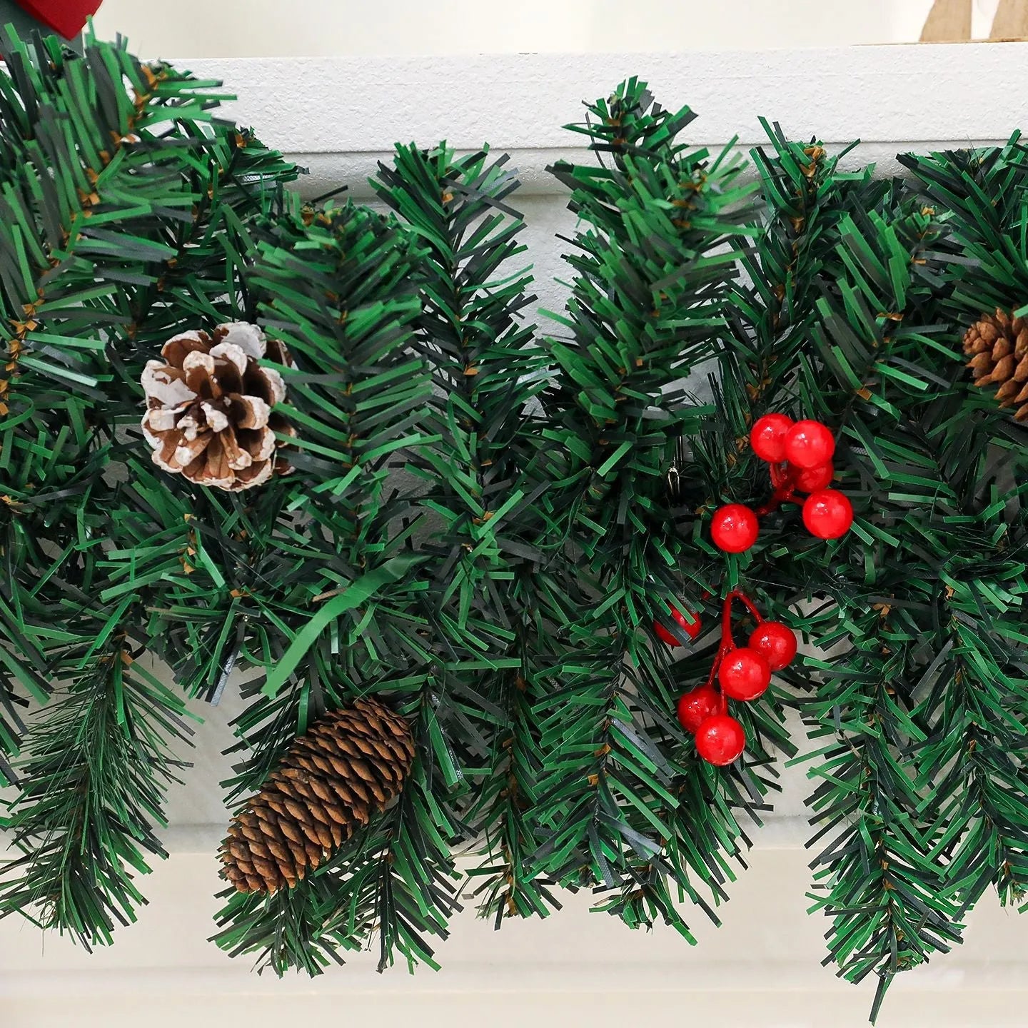 Christmas decorative rattan cane with pine cones and a red bow, available with or without integrated LED lights