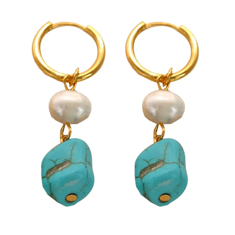 A pair of irregular shaped geometric copper ear clip earrings featuring turquoise stones and cultured pearls.