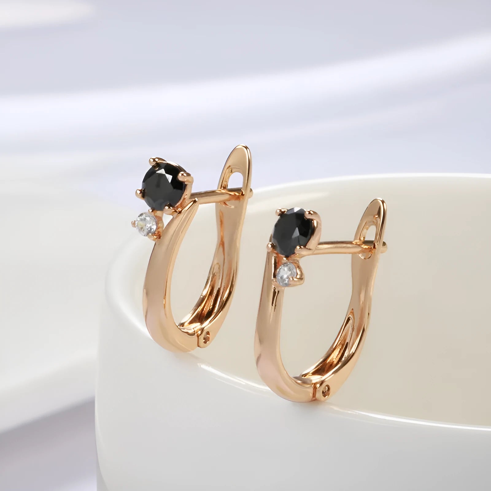 Gold geometric drop shape earrings with retro design and stone inlay on copper.
