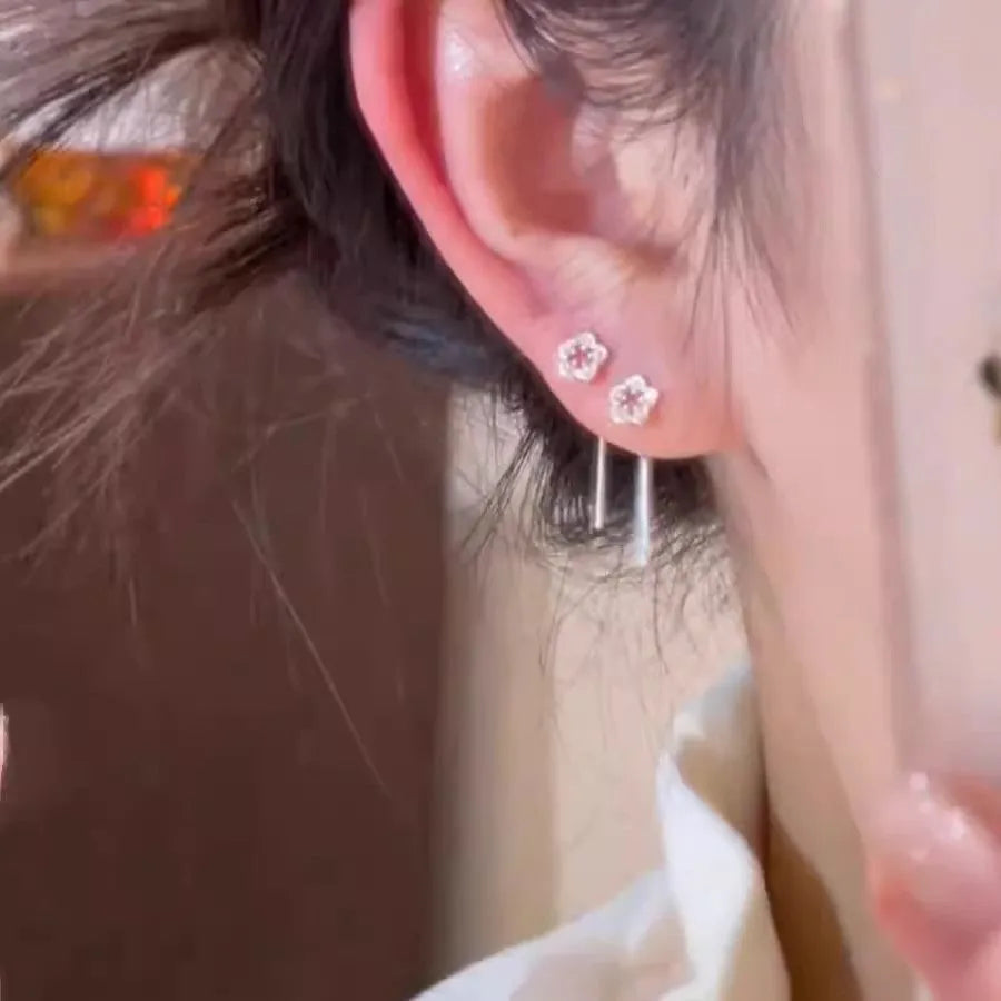 Silver hollow flower hanging earrings with petal design and alloy construction