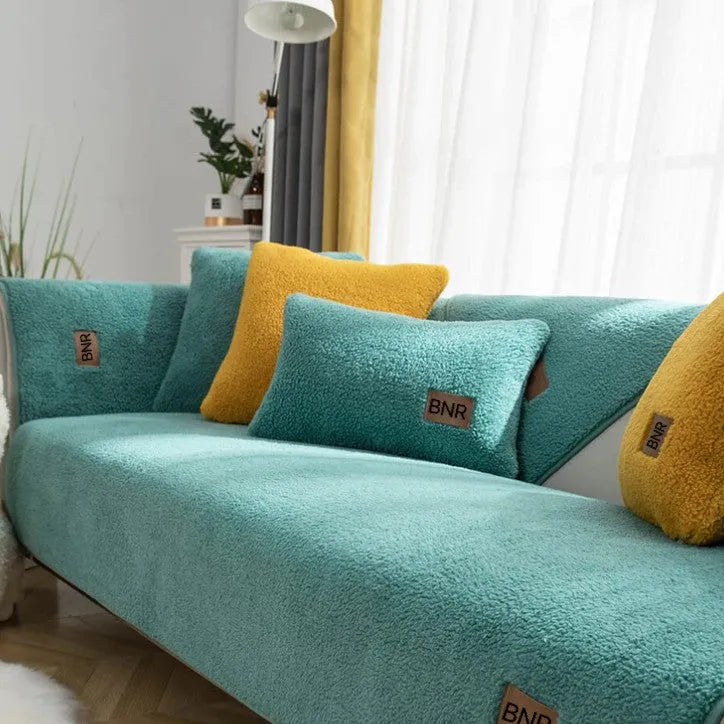 Lambswool solid colour sofa cover in blue, shown on a three-seater sofa.