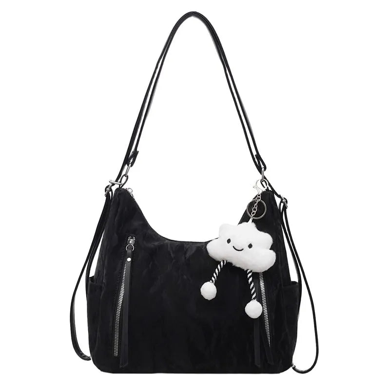 Women's soft PU fashion backpack in black, shown as a multi-functional shoulder bag with a pendant accessory.