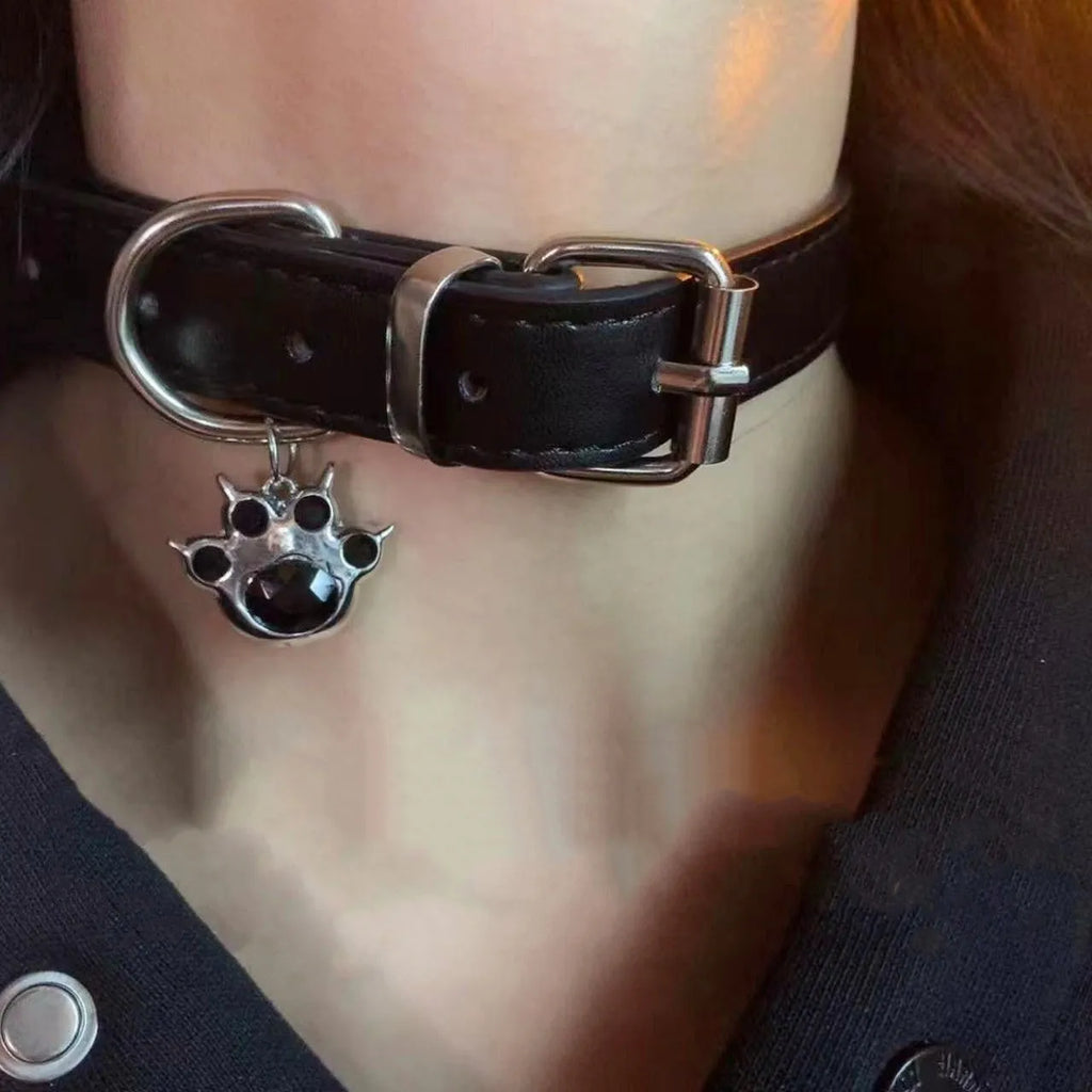 Black adjustable dog collar with bell showing three design options: LD leather, bone pattern, and cat's paw
