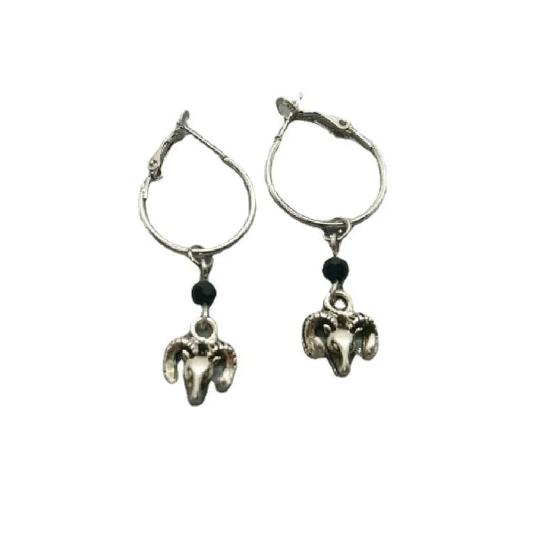 Silver-coloured alloy round hoop earrings with closed loop design on white background