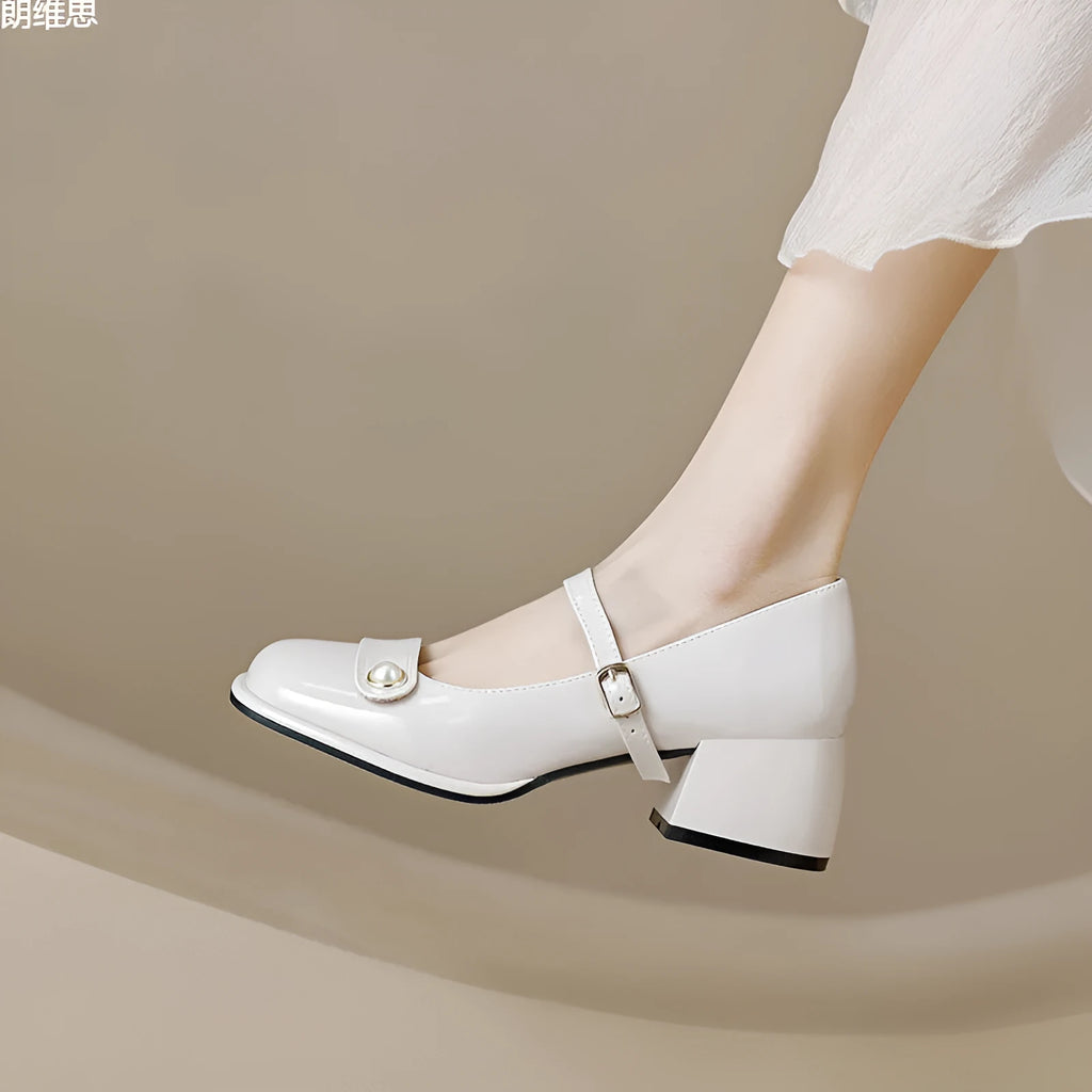 Women's apricot patent leather chunky heel pumps with a square toe and front buckle fastening.