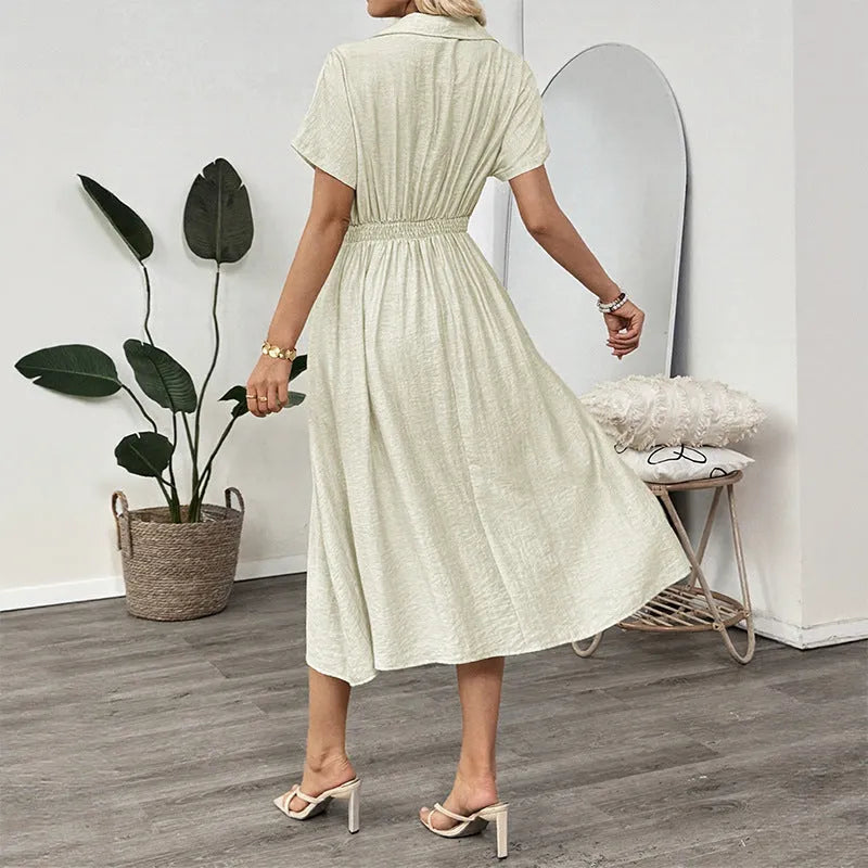 Light green knee-length shirt dress with lapel collar, waist tie, and side pockets on mannequin
