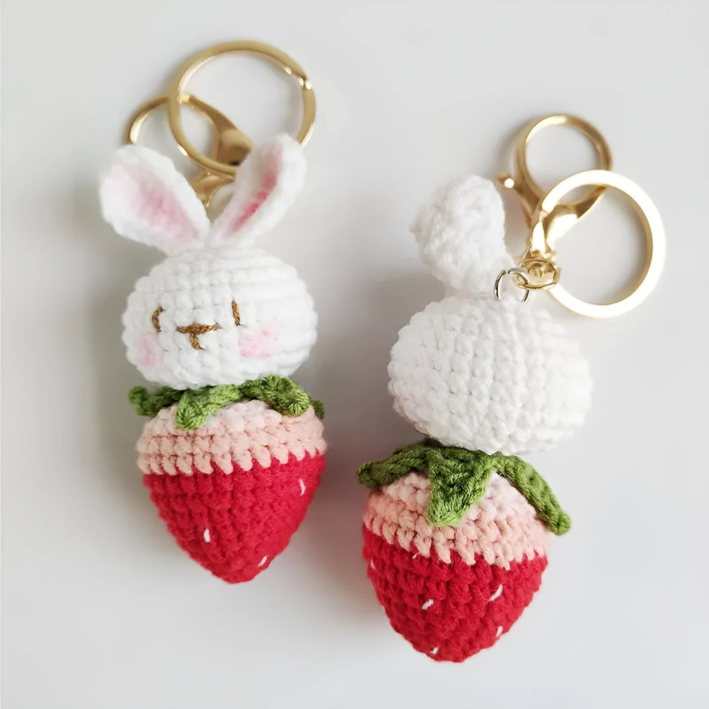 White hand-woven wire pendant with rabbit strawberry cartoon pattern and key attachment.