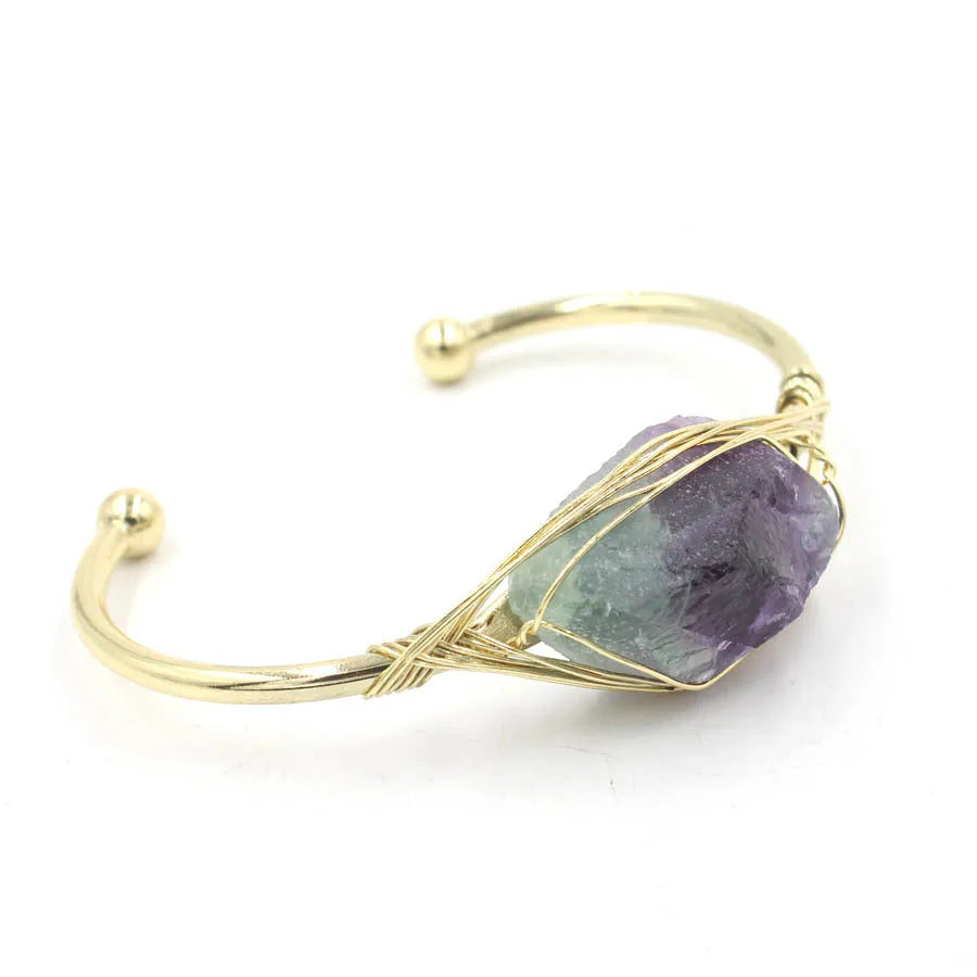 Raw gemstone winding bracelet with 8mm amorphous crystal beads in various colours on a white background.