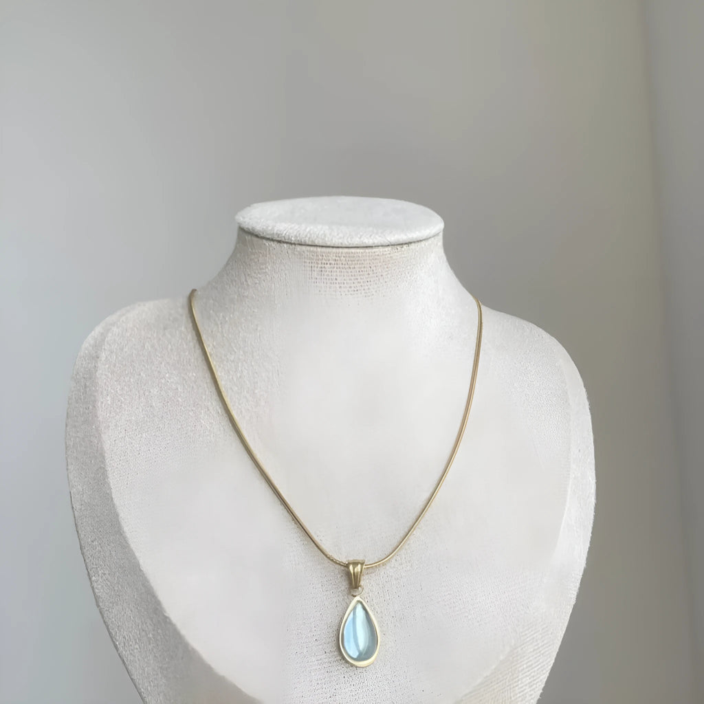 Retro water drop necklace with blue gemstone pendant on a titanium steel snake bone chain.