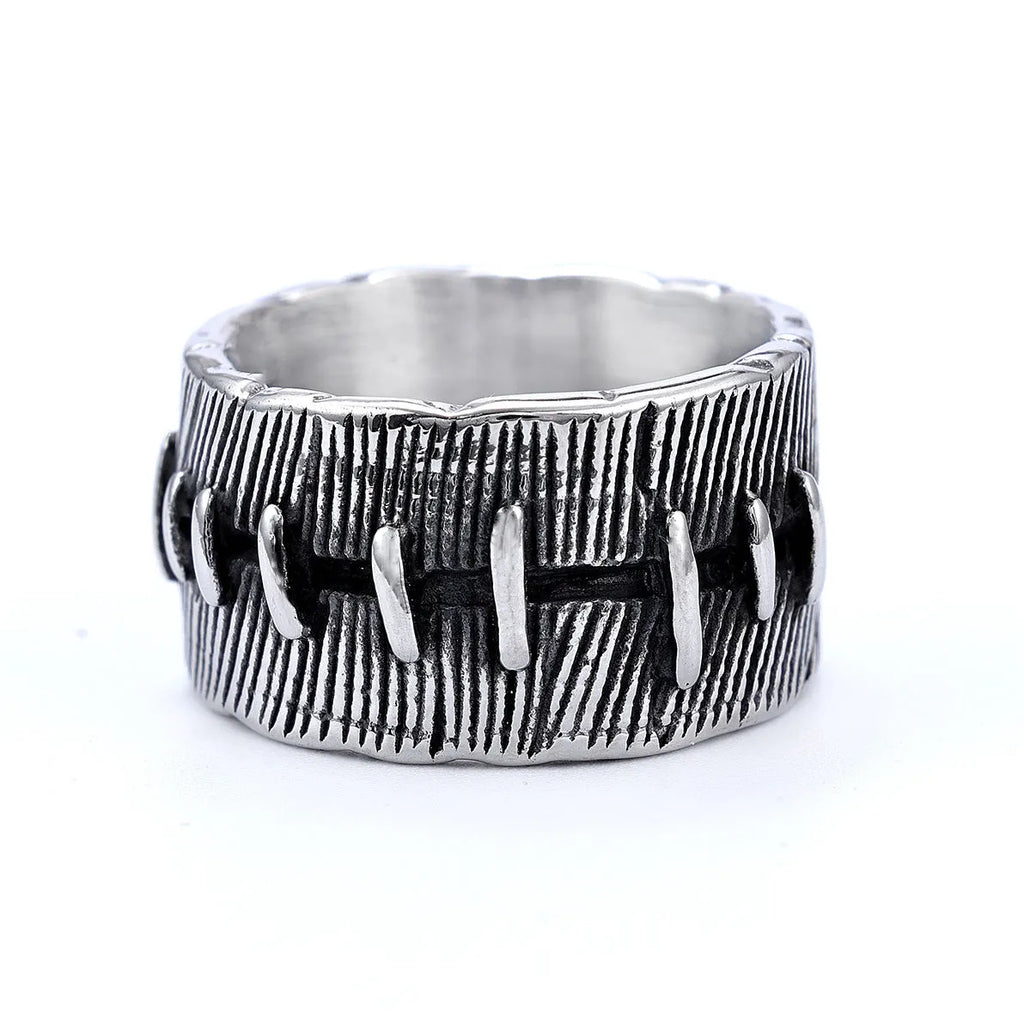 Geometric dark punk titanium steel double ring in retro colour on a black background.