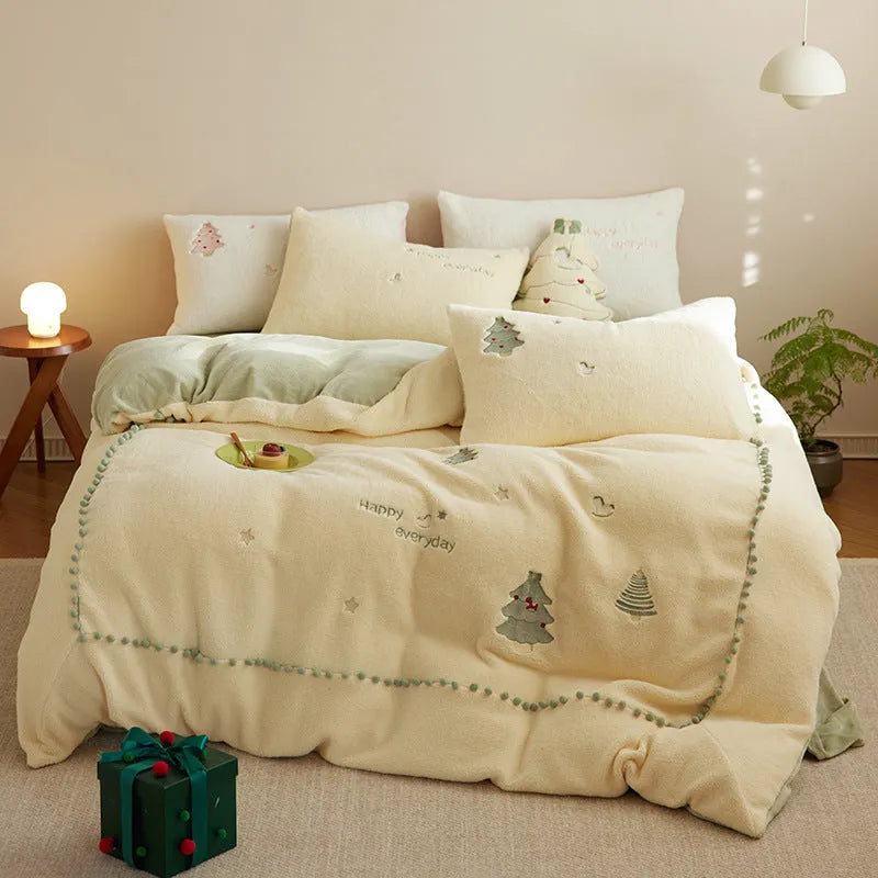 Winter milk fibre four-piece bedding set with green Christmas tree pattern on bed