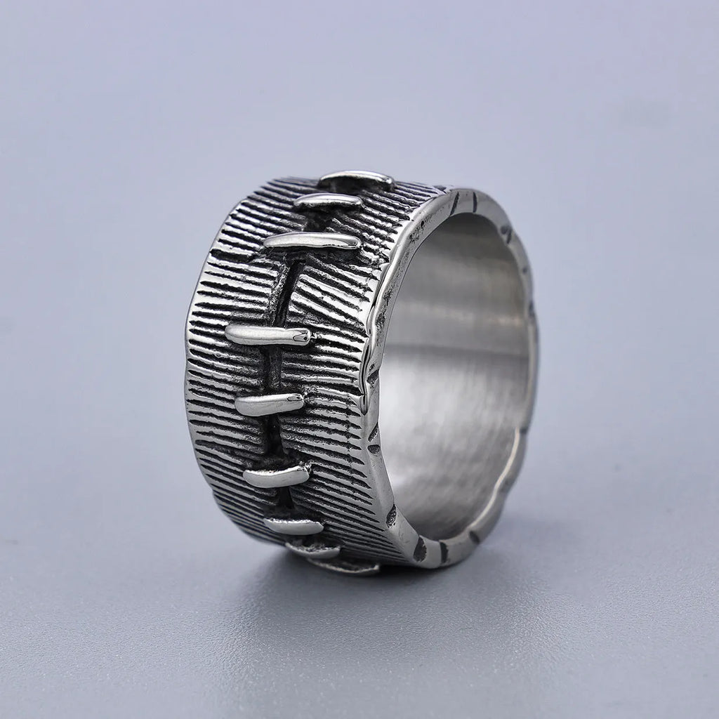 Geometric dark punk titanium steel double ring in retro colour on a black background.