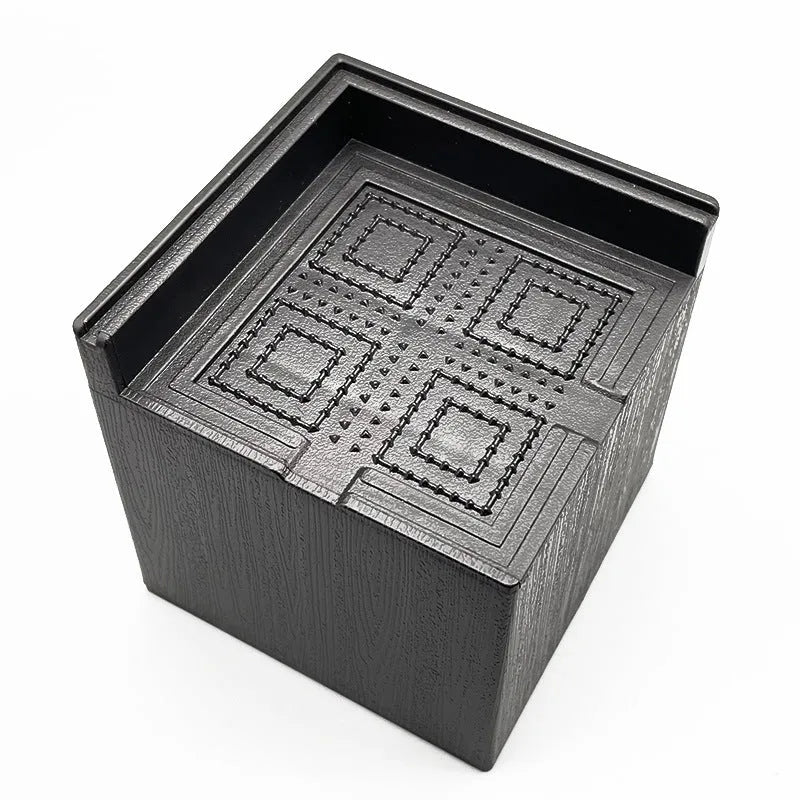 Four black circular plastic bed foot mats for furniture levelling and floor protection