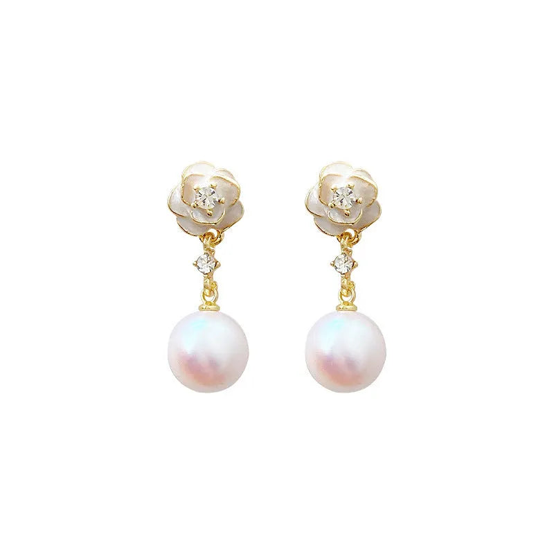 Close-up of women's camellia flower stud earrings in alloy with floral design.
