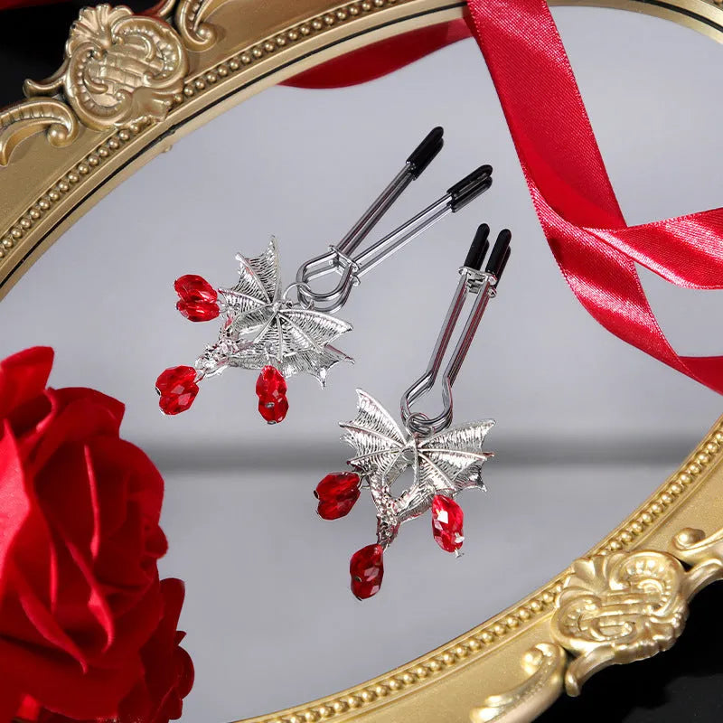 Silver alloy diamond bat nipple clamp set with ruby clip details and adjustable tension mechanism
