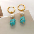 A pair of irregular shaped geometric copper ear clip earrings featuring turquoise stones and cultured pearls.