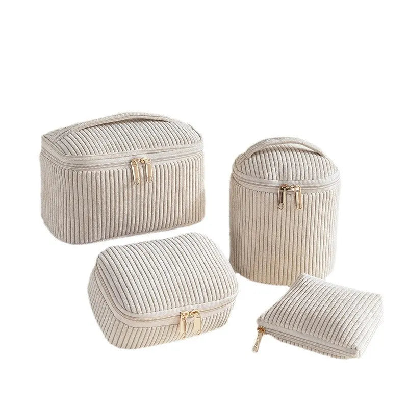 Four cube-shaped flannelette makeup bags in different colours for travel storage
