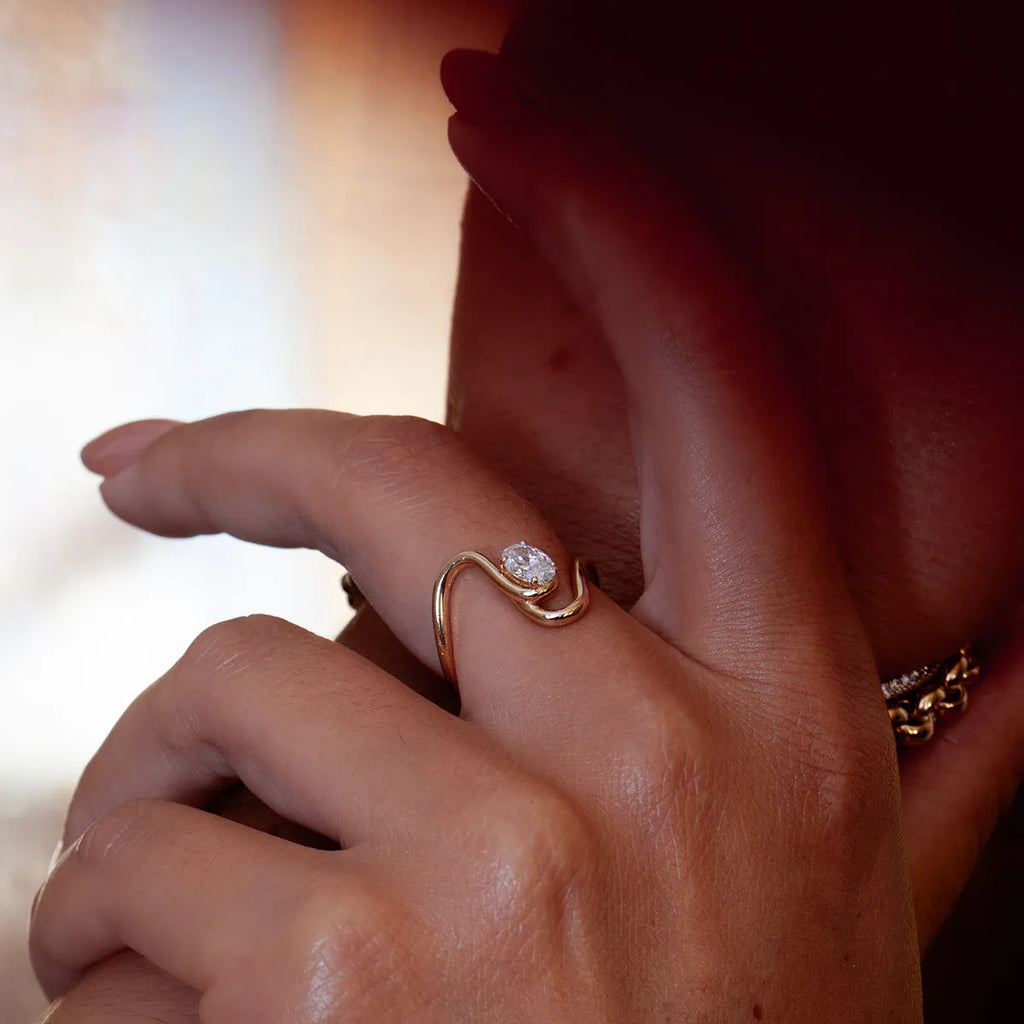 Geometric titanium steel zircon ring in a European American style on a plain background.