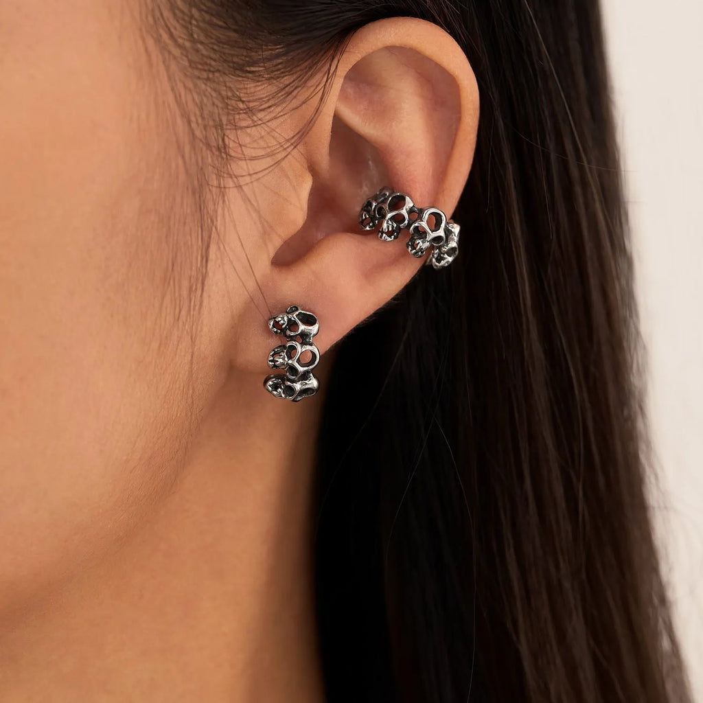 Stainless steel skull ear clip earrings with geometric hollow design and metallic finish