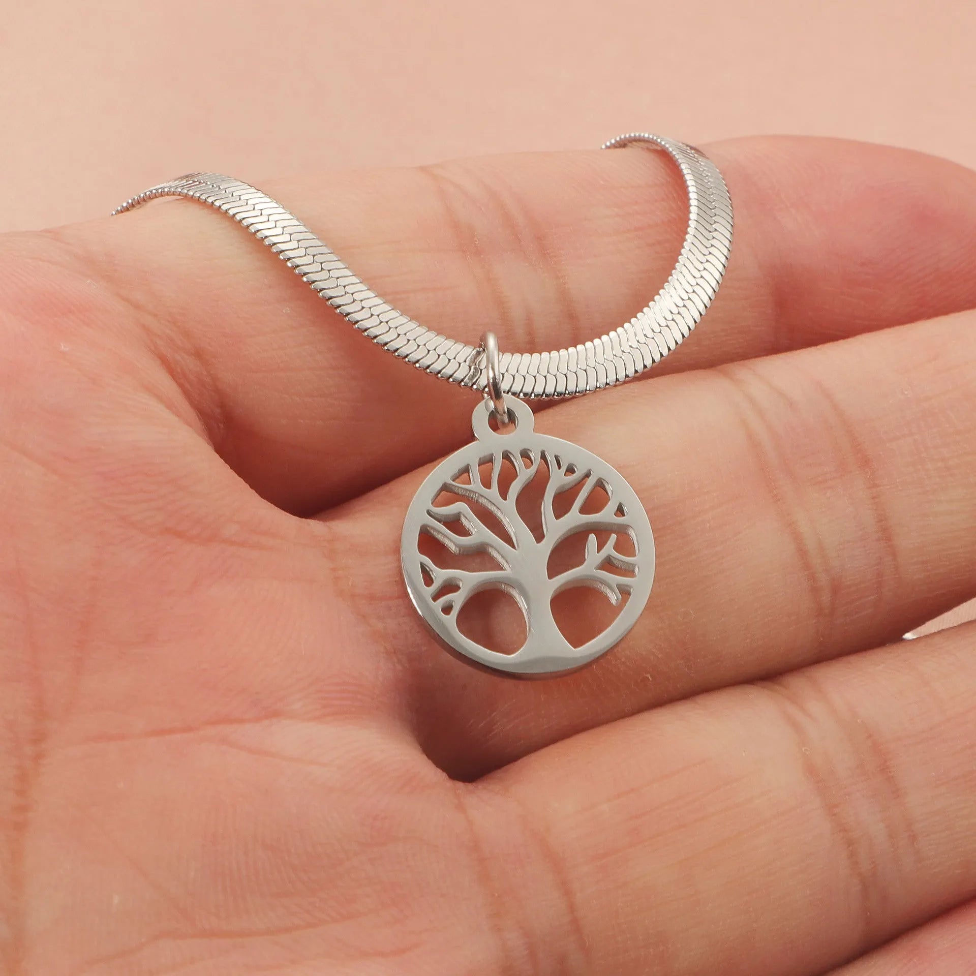 Stainless steel lucky tree pendant necklace on a snake bone chain, shown in gold and steel colour options.
