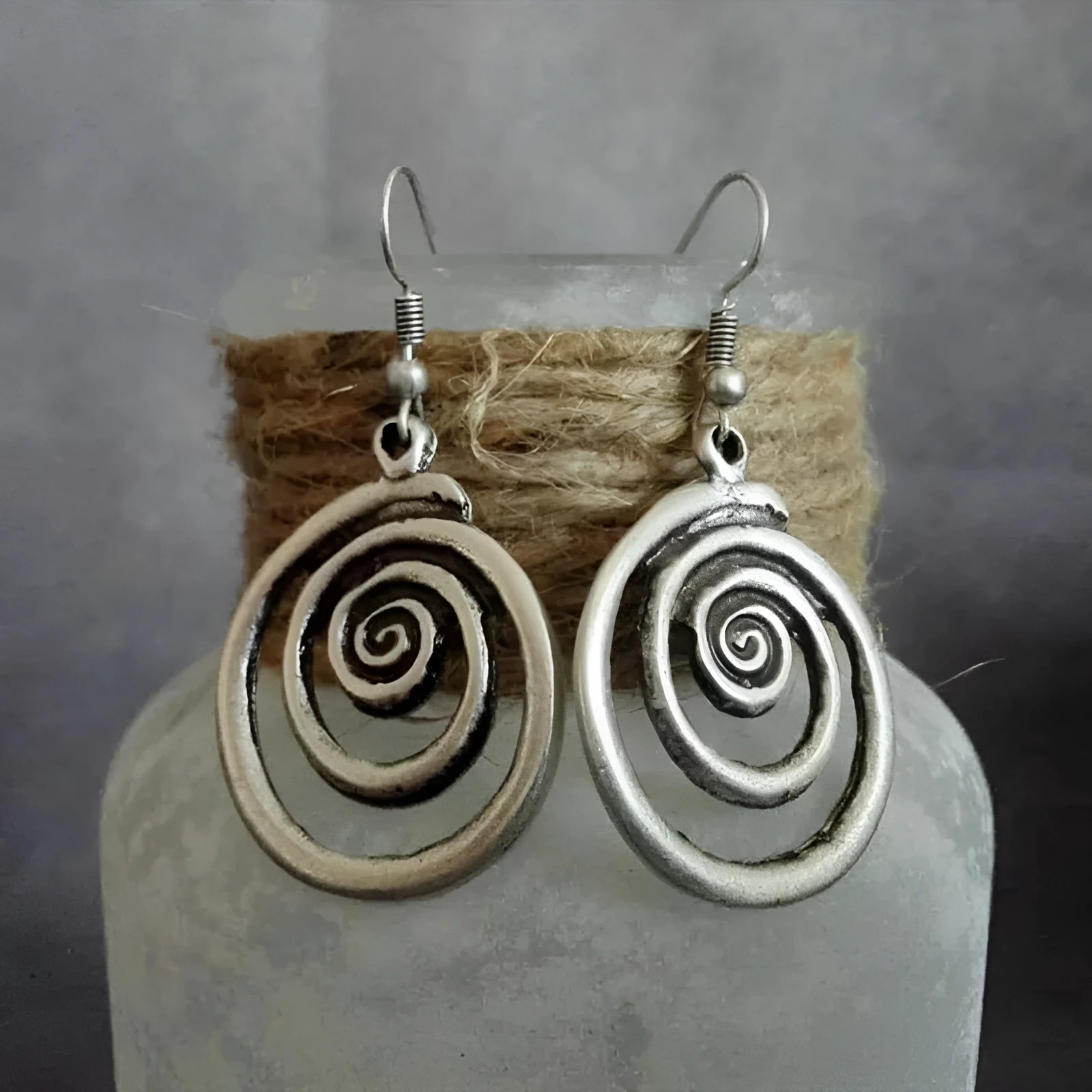Retro geometric spiral distressed silver alloy earrings showing textured finish and spiral shape