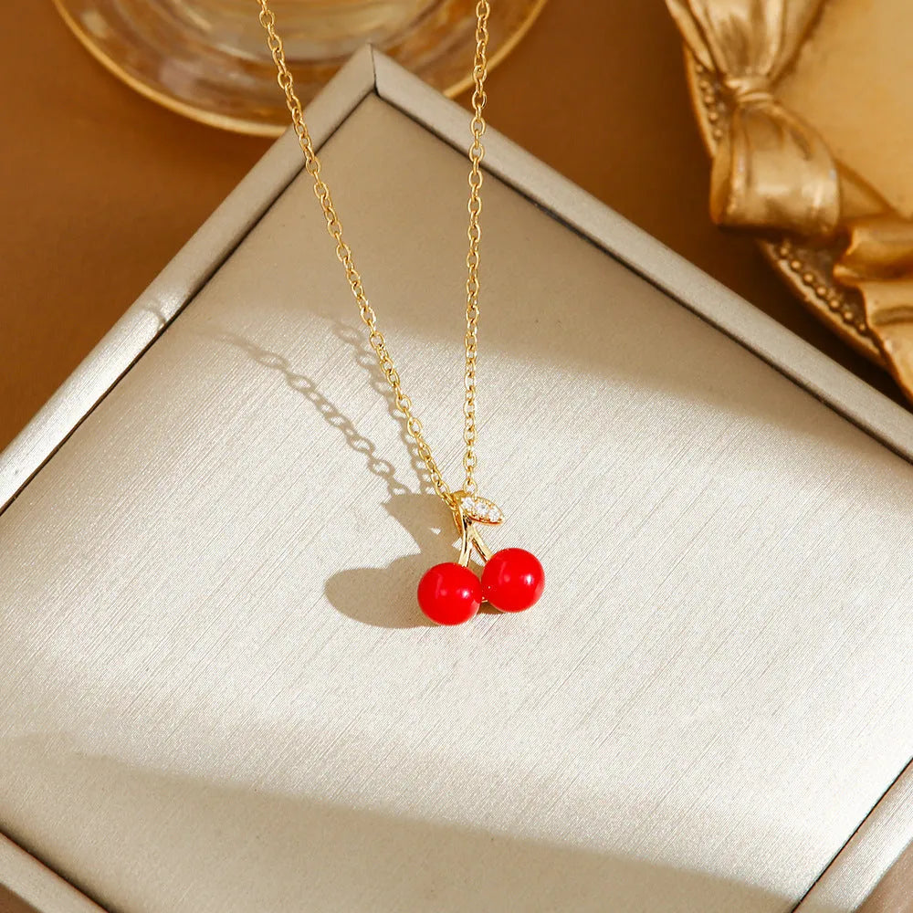 Delicate indie women's necklace with cherry, strawberry and pepper charms on a titanium steel O-ring chain.