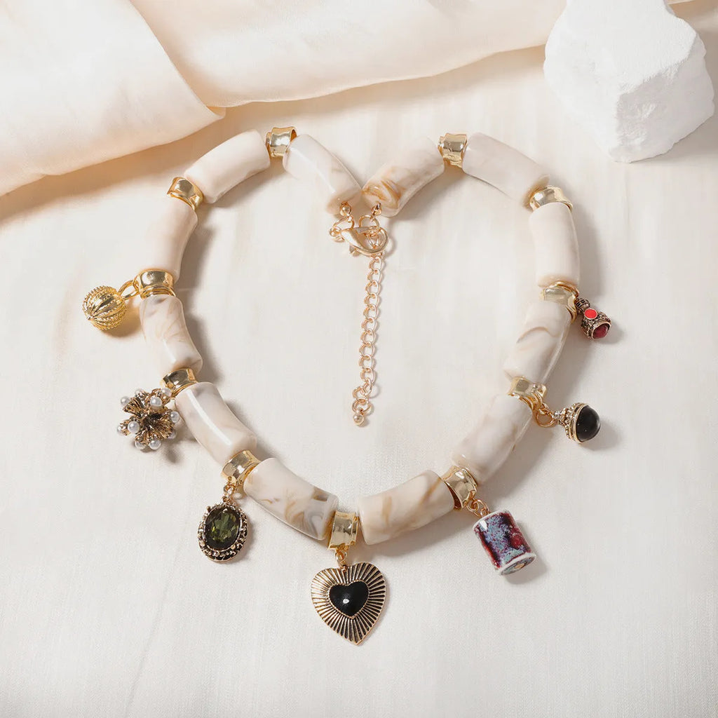 Close-up of a heart-shaped resin and bamboo pendant necklace with an electroplated finish.