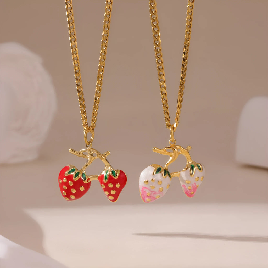 Close-up of a red stainless steel strawberry charm necklace on an alloy chain.