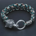 Handmade titanium steel wolf head bracelet in camouflage colour on wrist.