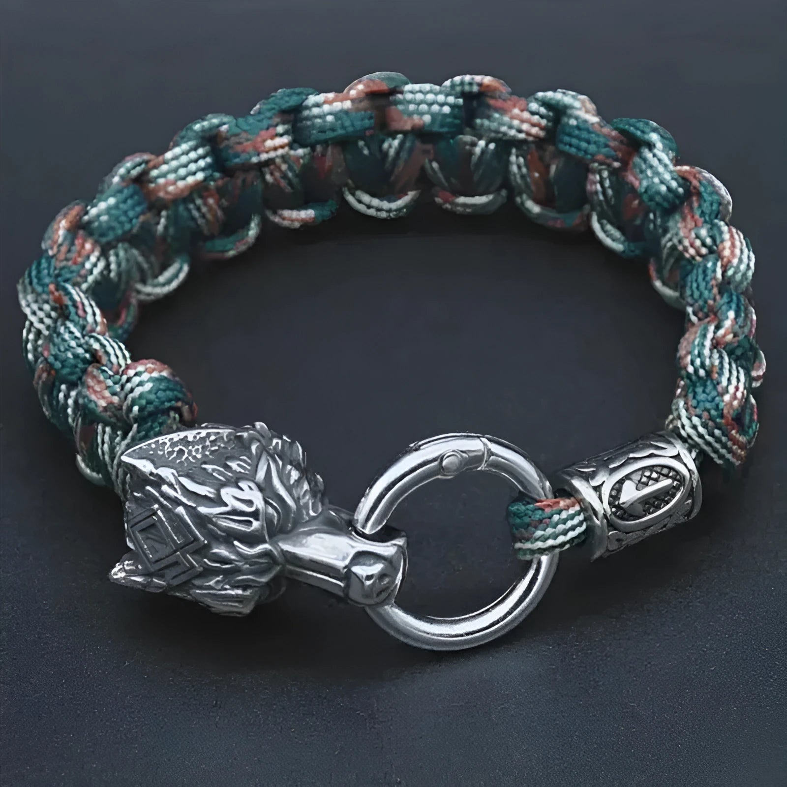 Handmade titanium steel wolf head bracelet in camouflage colour on wrist.