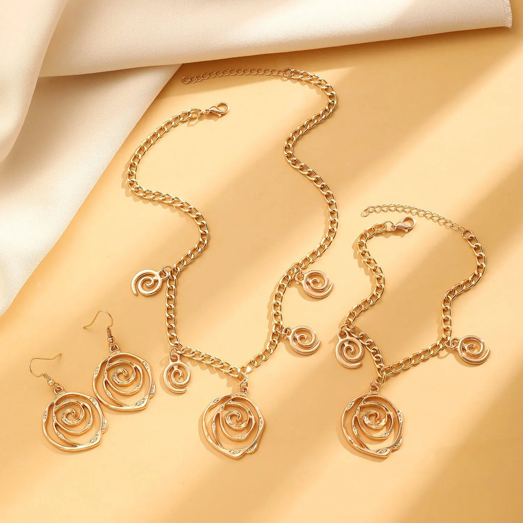Women's spiral donut jewellery set showing matching necklace, bracelet and ear hooks in gold or silver electroplated alloy