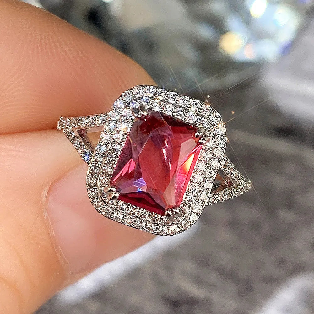 Square red copper women's ring with a central rhinestone on a white background.