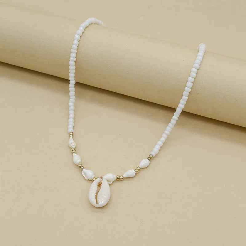 White Mother of Pearl conch shell necklace with regular chain on display