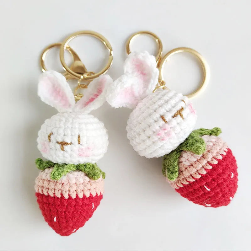 White hand-woven wire pendant with rabbit strawberry cartoon pattern and key attachment.