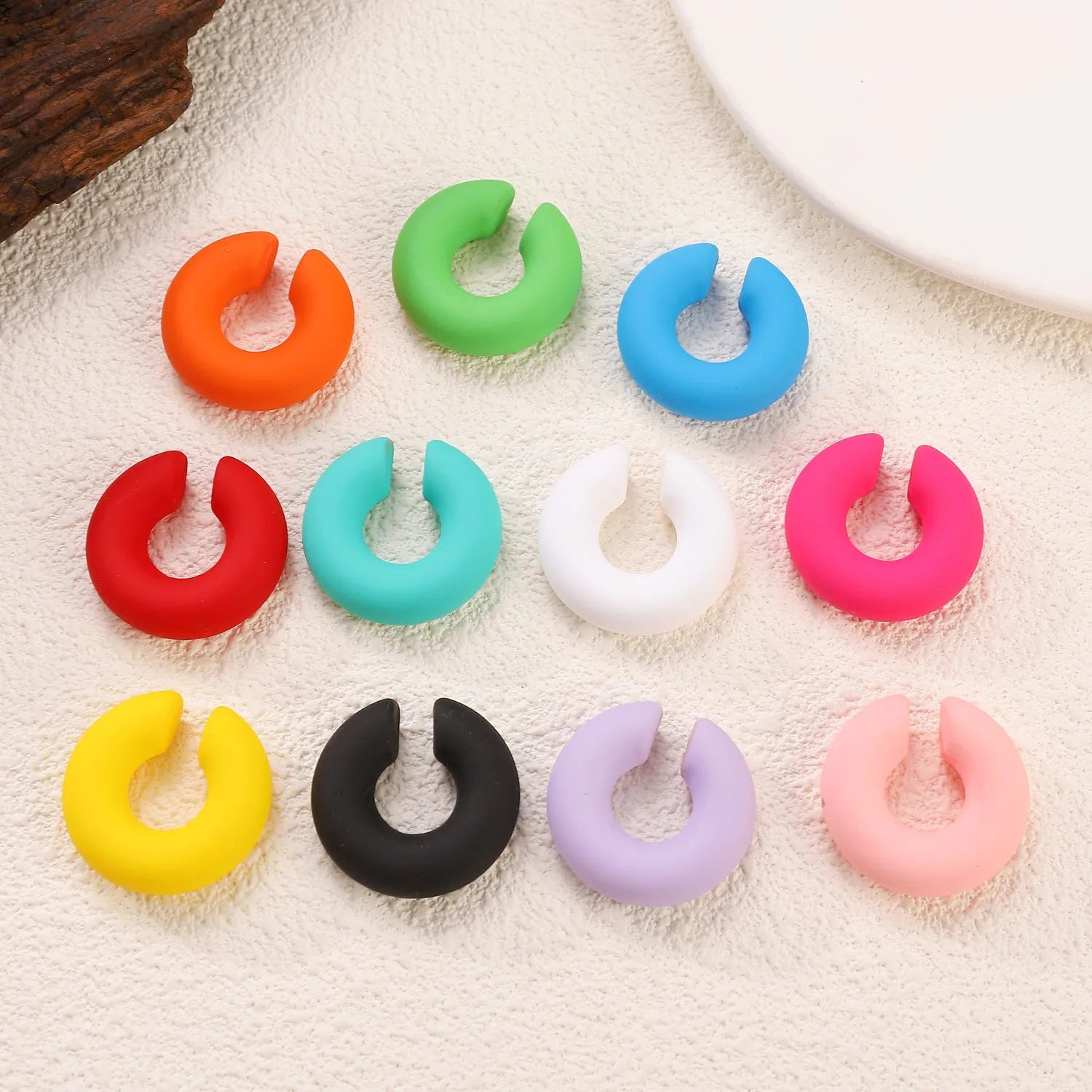 Matte coarse finish geometric C-shaped clip-on earrings for women in a selection of candy colours.