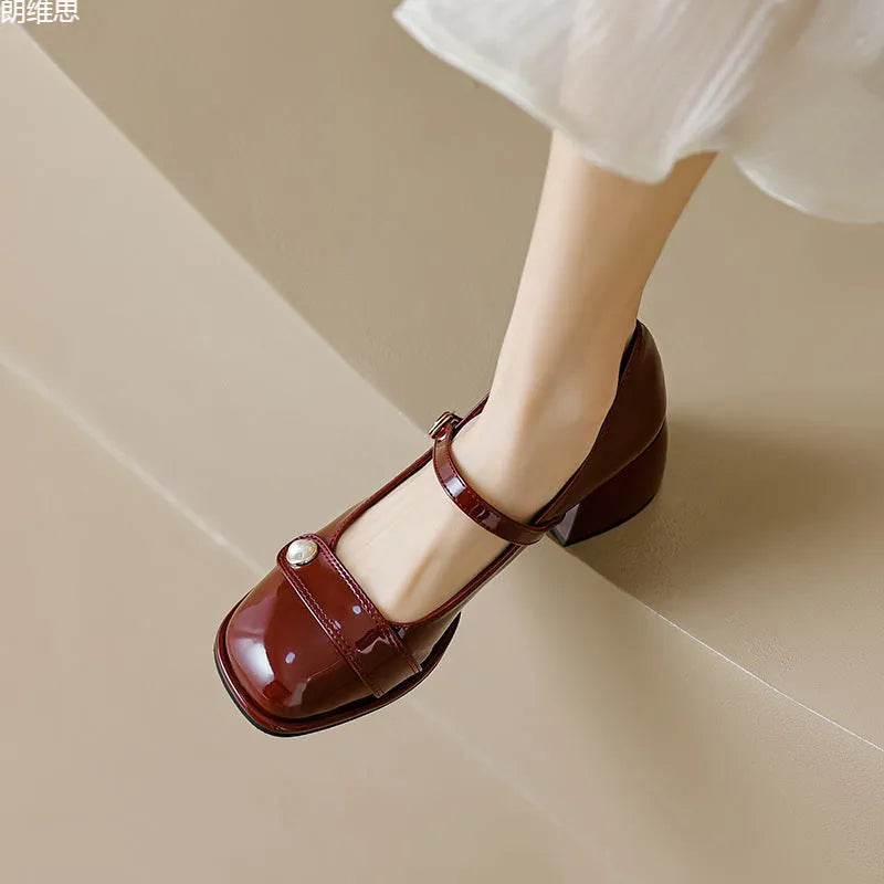 Women's apricot patent leather chunky heel pumps with a square toe and front buckle fastening.